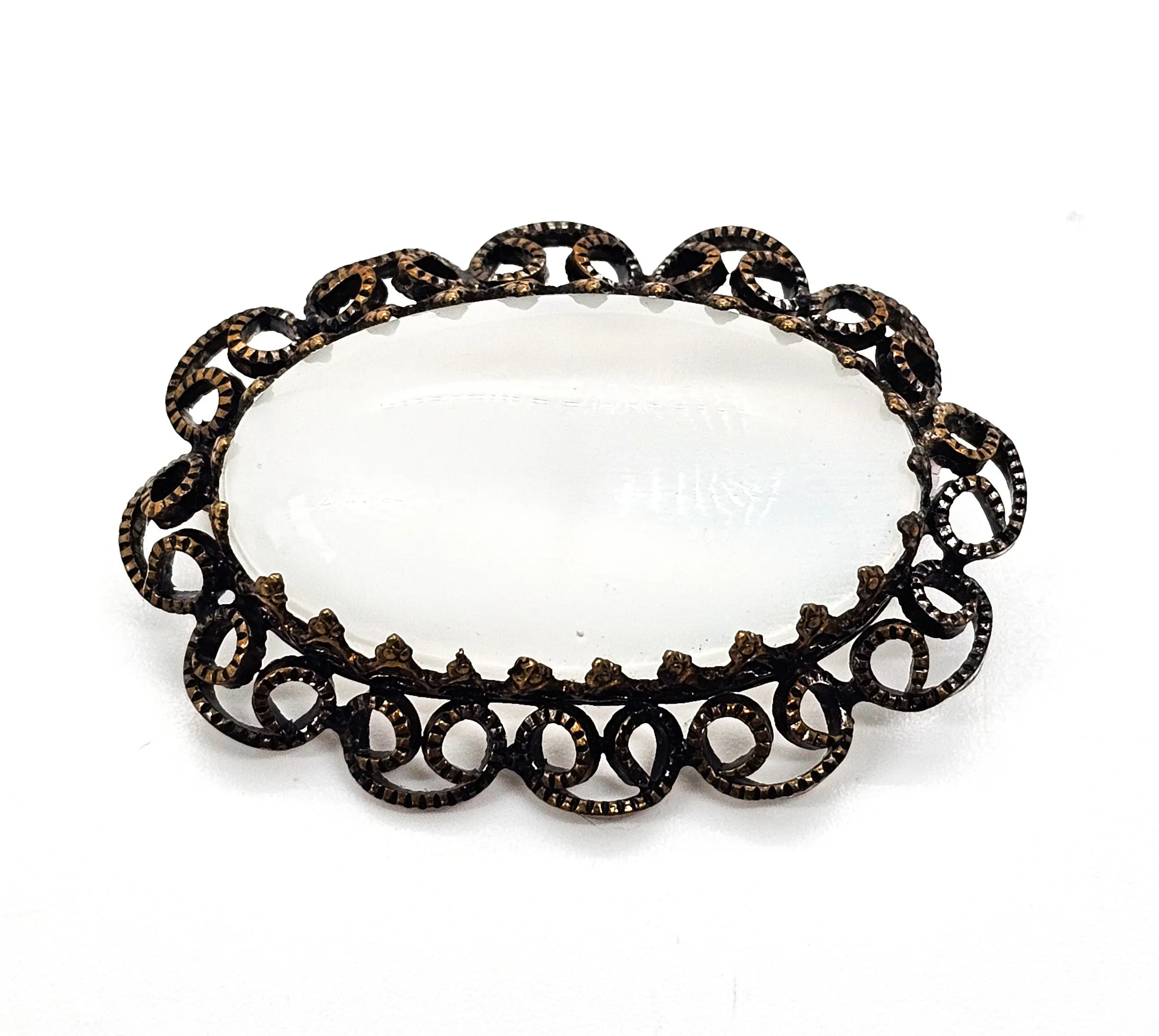 Austrian white Cat's Eye moonglow glass with filigree frame vintage brooch