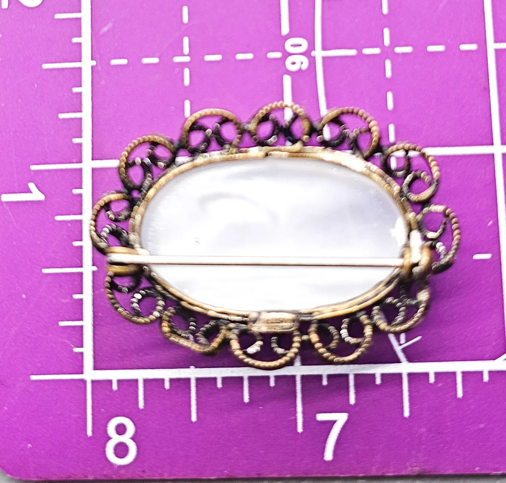 Austrian white Cat's Eye moonglow glass with filigree frame vintage brooch
