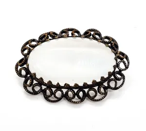 Austrian white Cat's Eye moonglow glass with filigree frame vintage brooch