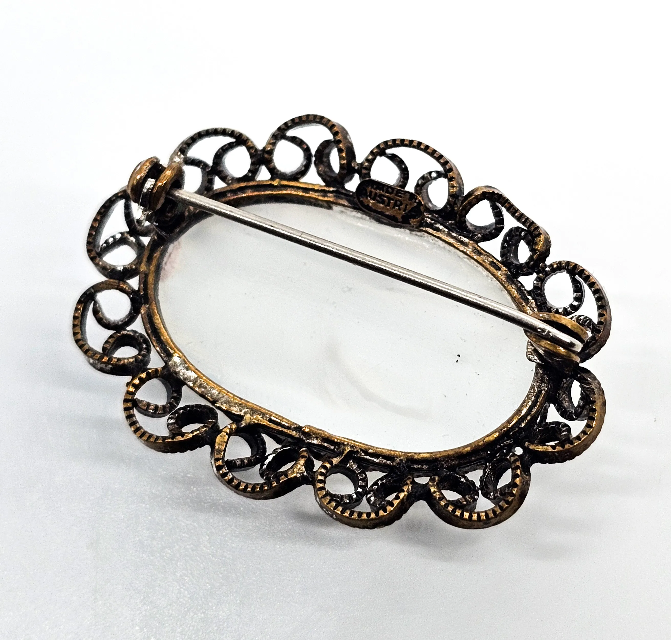 Austrian white Cat's Eye moonglow glass with filigree frame vintage brooch
