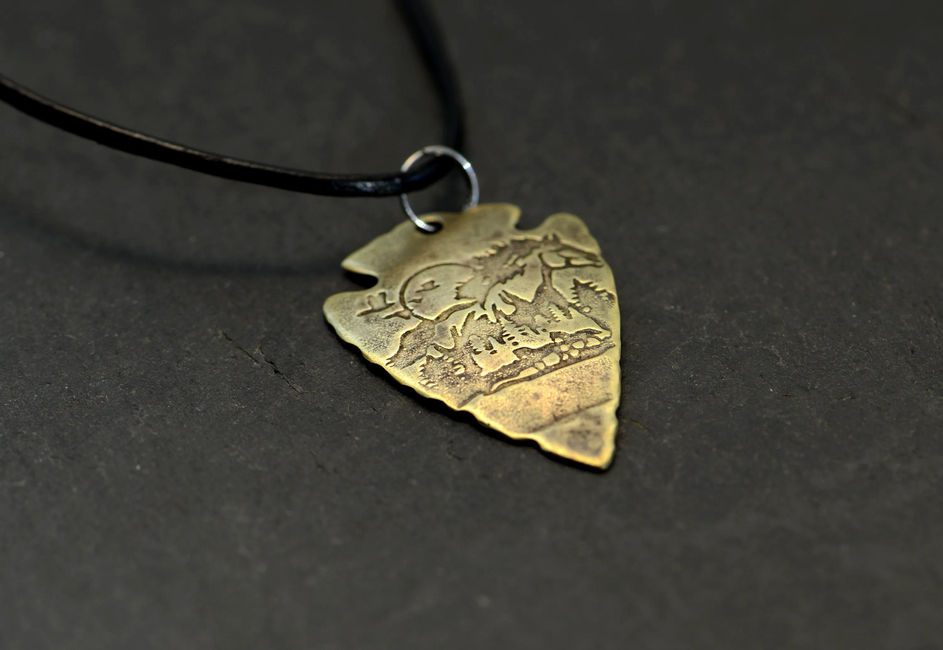 Bronze arrowhead necklace with horses and mountains