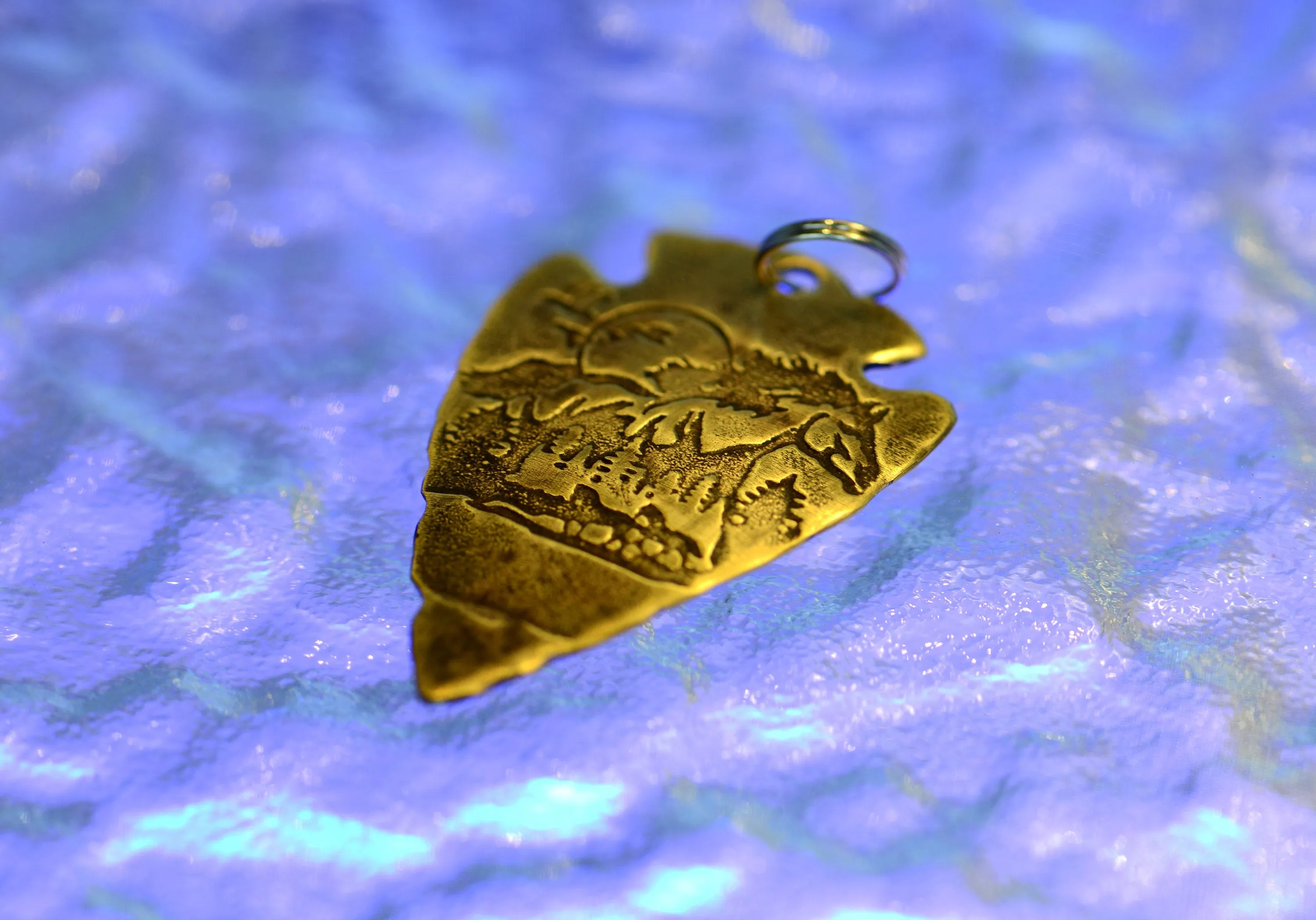 Bronze arrowhead necklace with horses and mountains