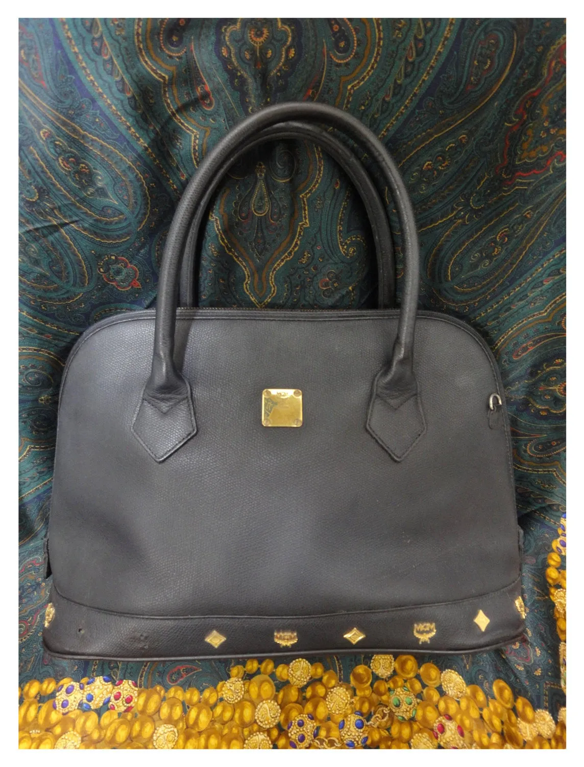 Vintage MCM black bolide style bag with gold tone metal studded charms. Rare masterpiece purse for unisex use. Phenomenon