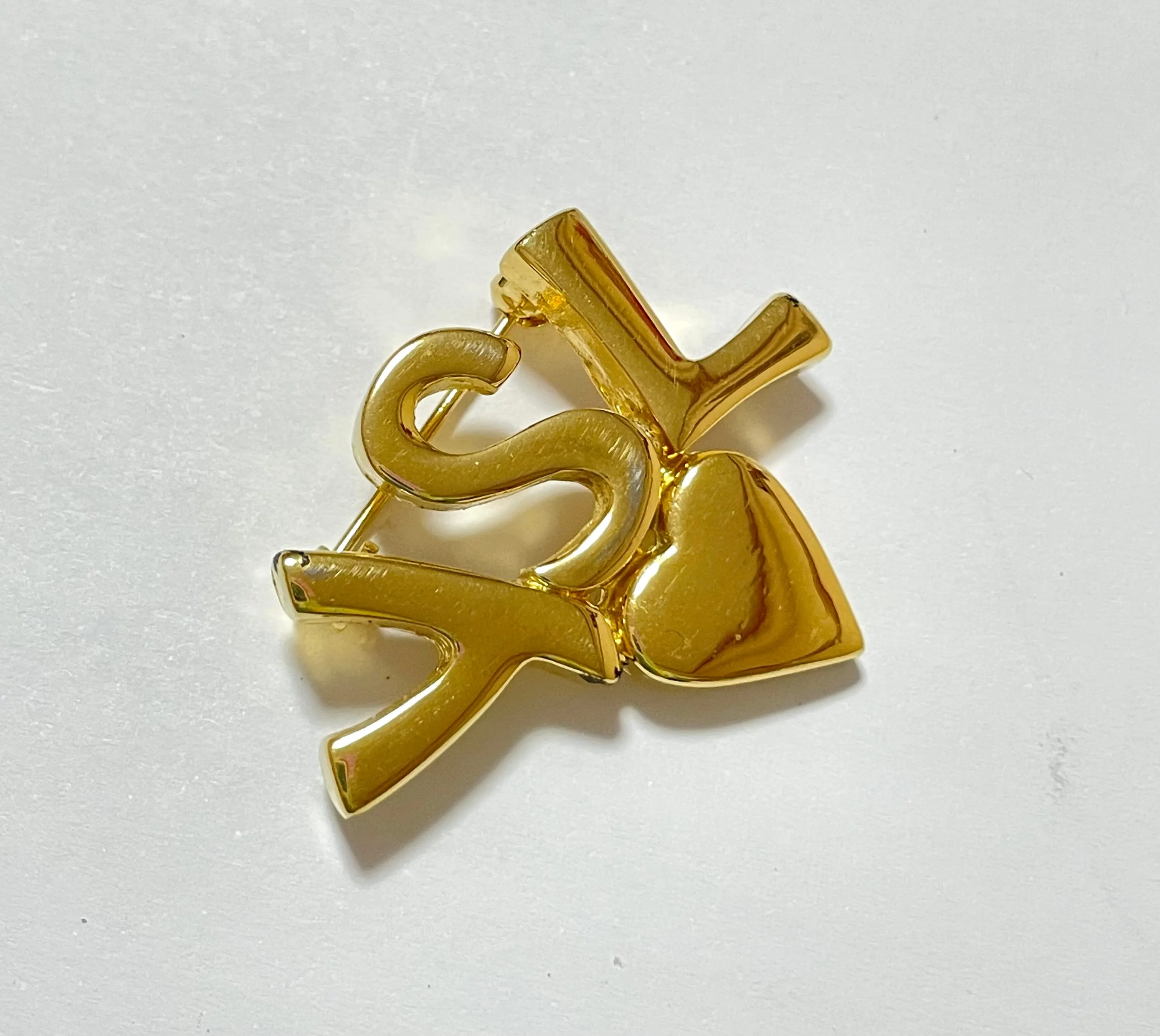 W2 Vintage Yves Saint Laurent classic YSL logo and heart brooch. Perfect pin for hat, scarf, jacket etc. Great gift.0408173
