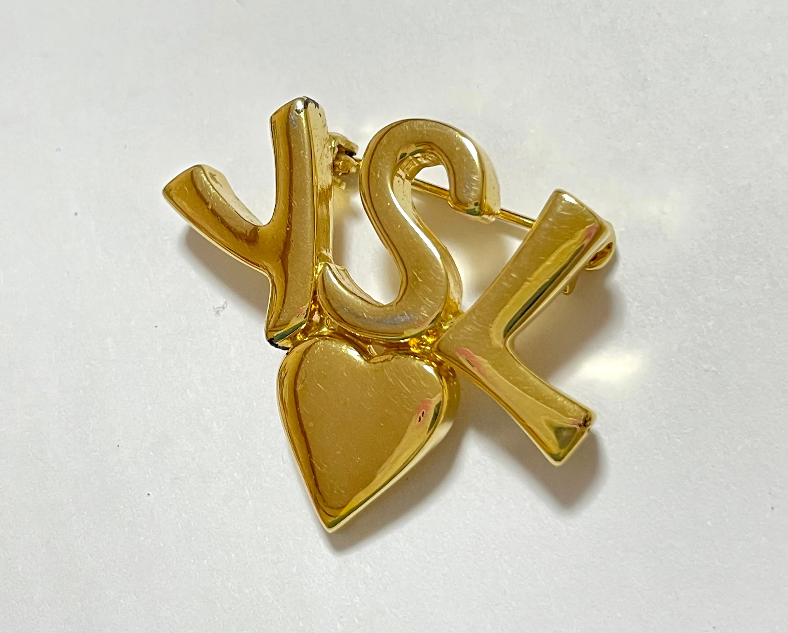W2 Vintage Yves Saint Laurent classic YSL logo and heart brooch. Perfect pin for hat, scarf, jacket etc. Great gift.0408173