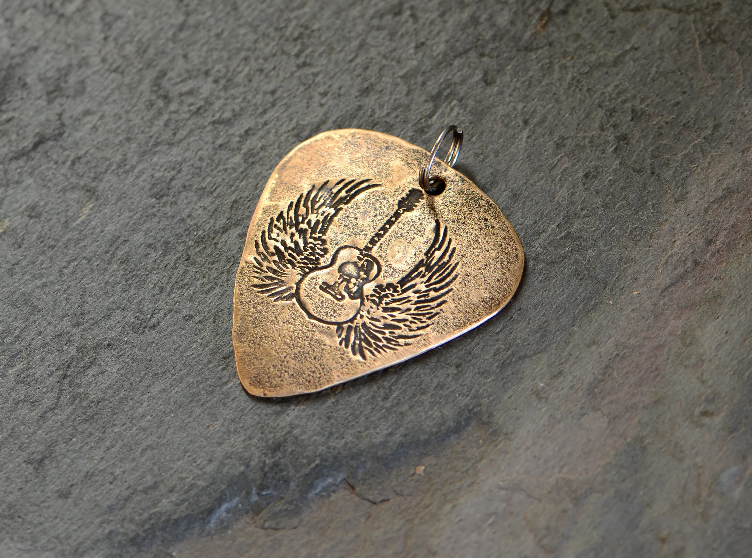Winged guitar on bronze guitar pick necklace