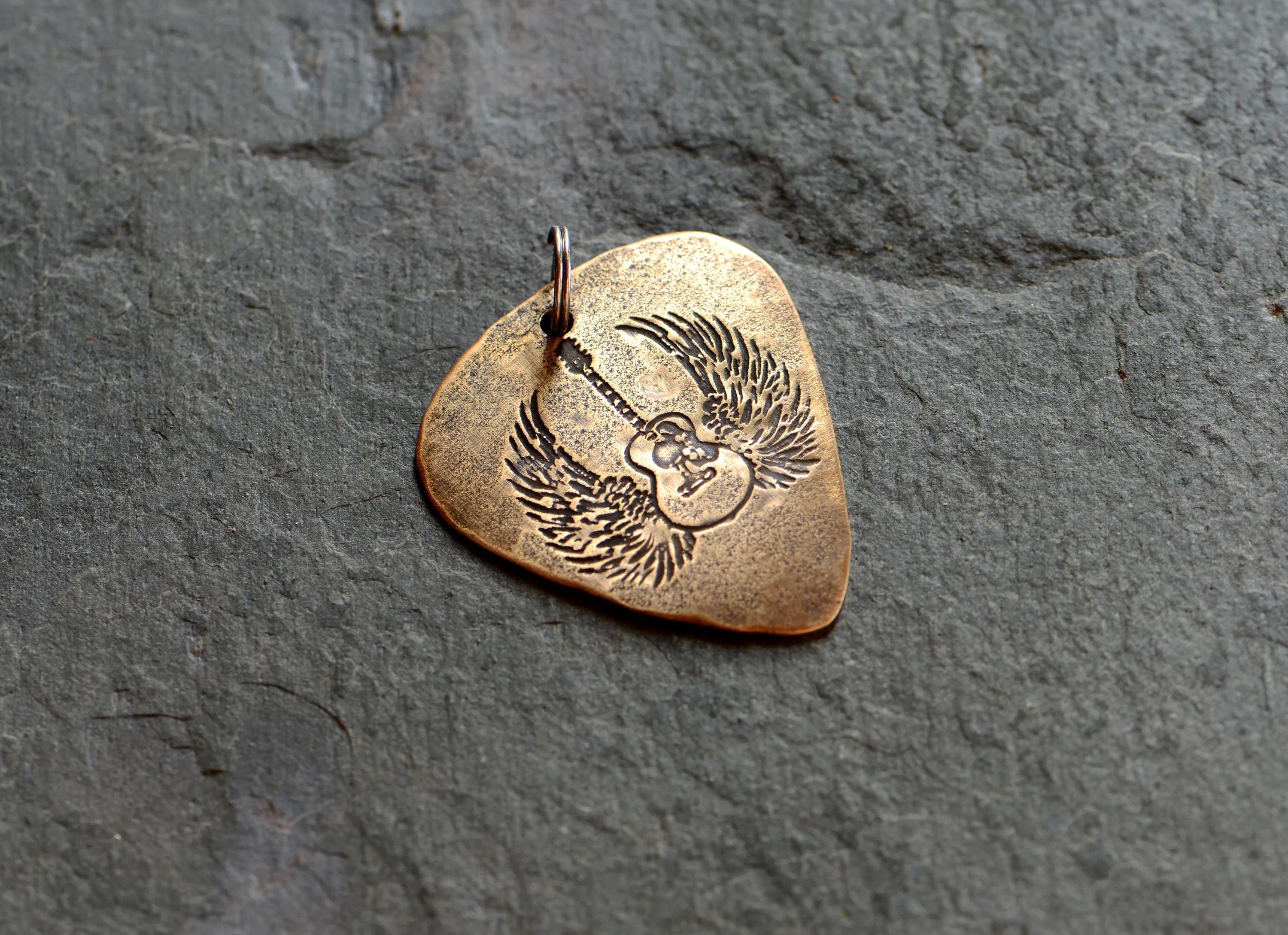 Winged guitar on bronze guitar pick necklace