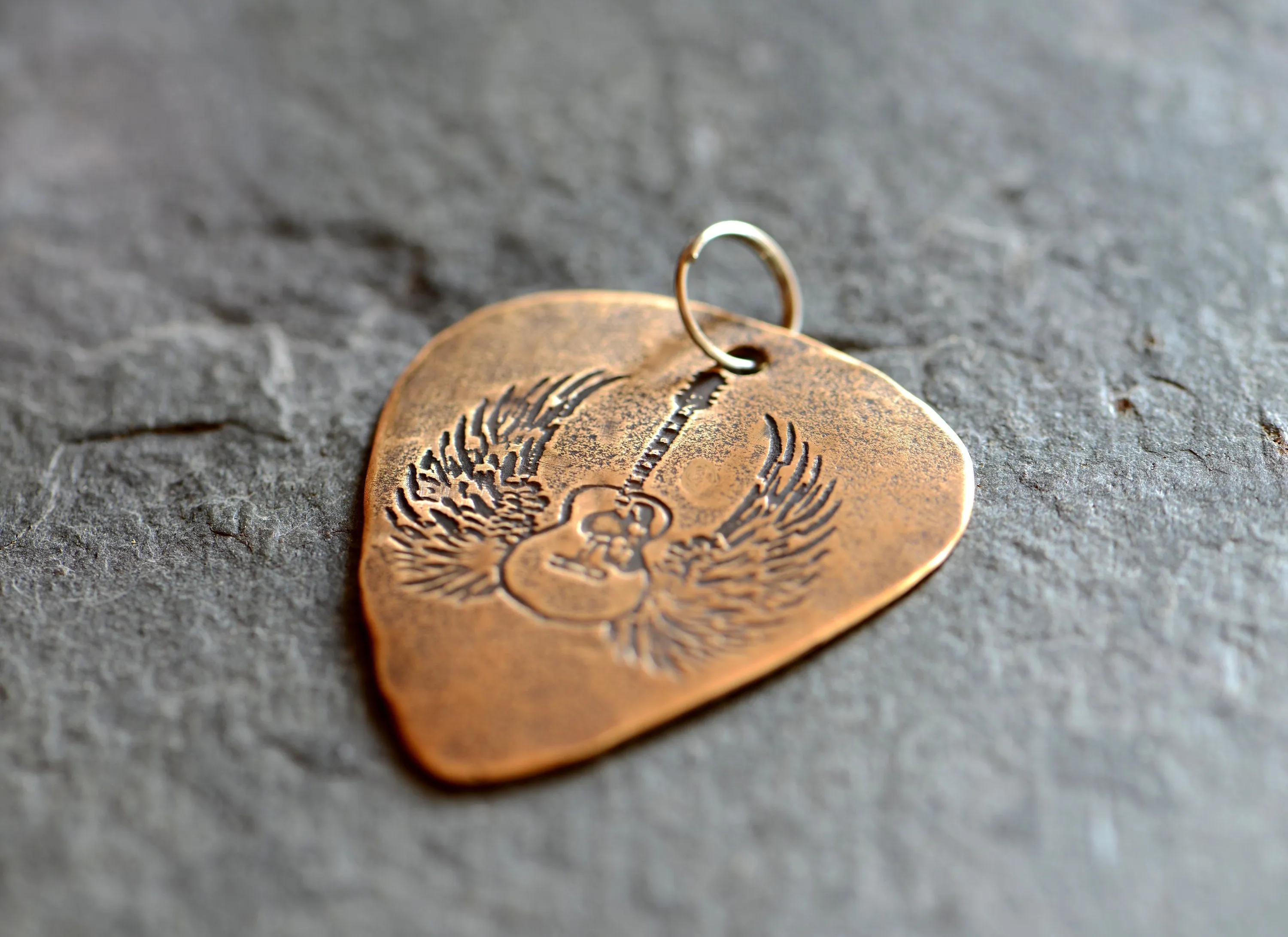 Winged guitar on bronze guitar pick necklace